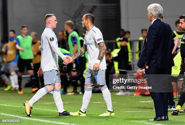 Wayne Rooney of Everton FC shakes hands with Sandro Ramirez of Everton FC after being substituted during the UEFA Europa League group E match between...