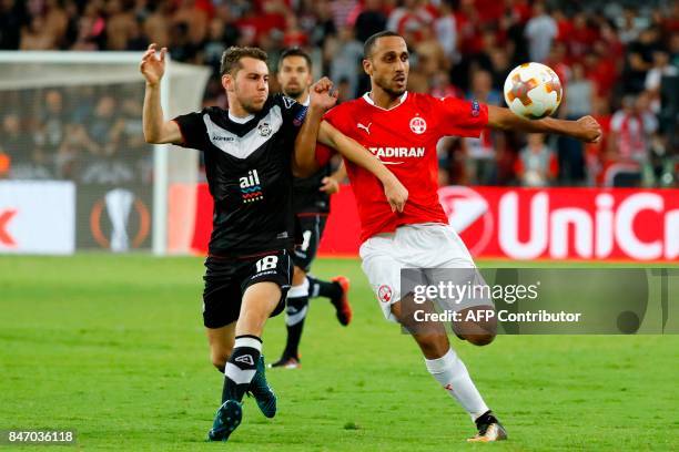 Lugano's Italian midfielder Mario Piccinocchi plays against Hapoel Beer-Sheva's Israeli midfielder Maharan Radi during the UEFA Europa League...