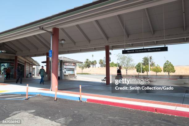 People walk along the platform at the North Concord/Martinez station for the Bay Area Rapid Transit regional high speed rail system, Concord,...