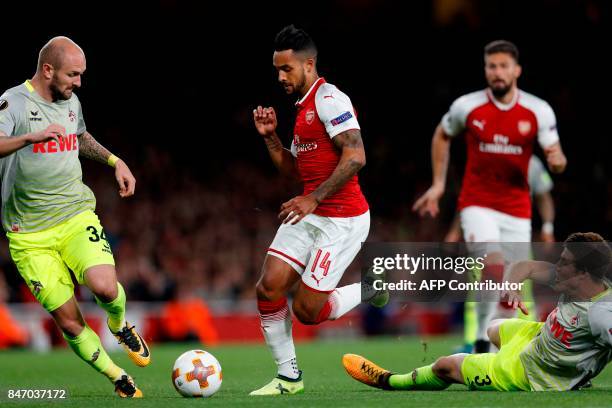 Arsenal's English midfielder Theo Walcott runs through the Cologne defence during the UEFA Europa League Group H football match between Arsenal and...