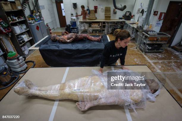 Artem employee Nolwenn Caro poses with a dummy of actor David Thewlis made for the 2015 "Macbeth" film on display during an open evening at the Artem...