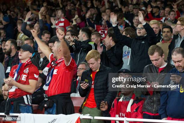 Arsenal fans stand next to 1.FC Koln fans as crowd segration apparently breaks down during the UEFA Europa League group H match between Arsenal FC...