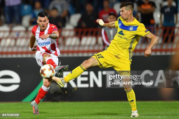 Crvena Zvezda's midfielder Nemanja Radonjic shoots the ball past Bate's midfielder Aleksei Rios during the UEFA Europa League match between FK Crvena...