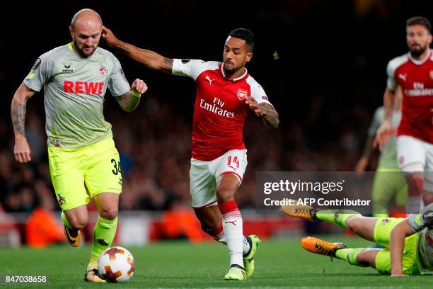 Cologne's German defender Konstantin Rausch vies with Arsenal's English midfielder Theo Walcott during the UEFA Europa League Group H football match...