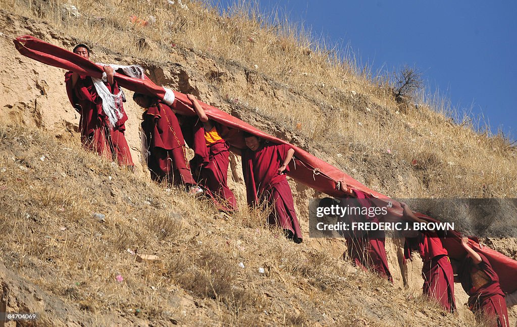 Tibetan Buddhist monks carry a huge than