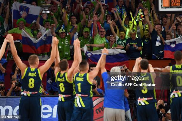 Slovenia's players celebrate their team's win with their supporters after the FIBA Eurobasket 2017 men's semi-final basketball match between Spain...