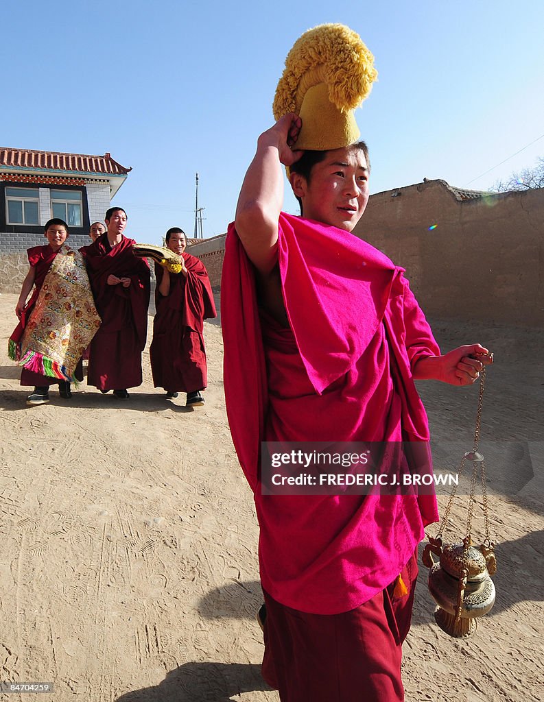 A Tibetan Buddhist monk carries an incen