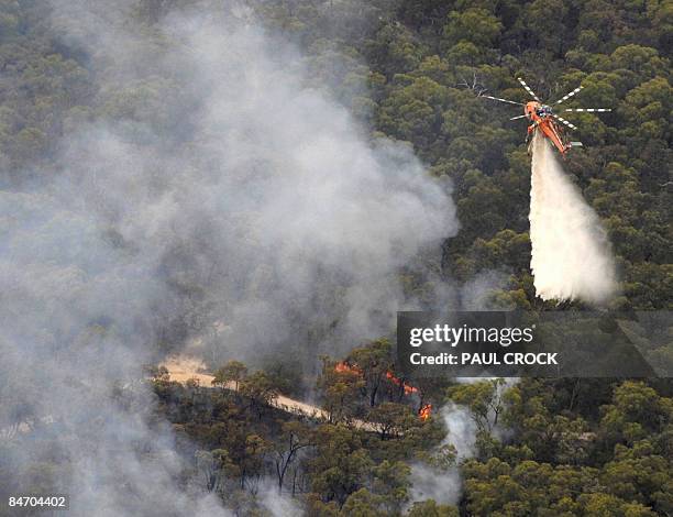 An aircrane fire-fighting aircraft dumps a load of water on the Bunyip Ridge wildfire which threatened electricity transmission lines near Bunyip,...