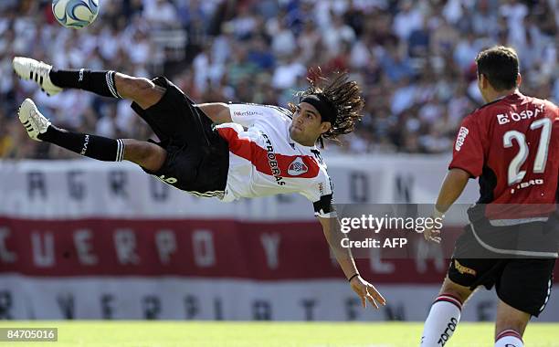 River Plate's Radamel Falcao Garcia kicks the ball over Alexis Ferrero of Colon during their Argentina first division football match, at Monumental...