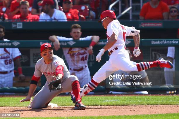 Kolten Wong of the St. Louis Cardinals fails to beat the throw to Joey Votto of the Cincinnati Reds for an out at first base in the sixth inning at...