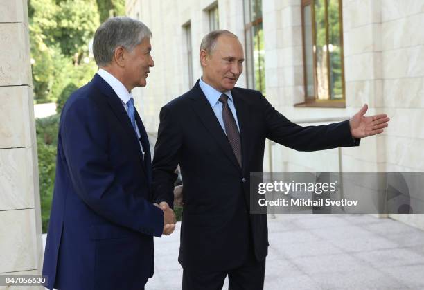 Russian President Vladimir Putin greets Kyrgyz President Almazbek Atambayev at the Bocharov Ruchey State Residence September 14, 2017 in Sochi,...