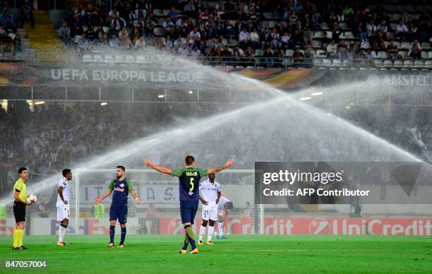 Referee from Azrbaijan Aliyar Aghayev stops the game due to the sprinklers activation during the Europa League football match Vitoria Guimaraes SC vs...
