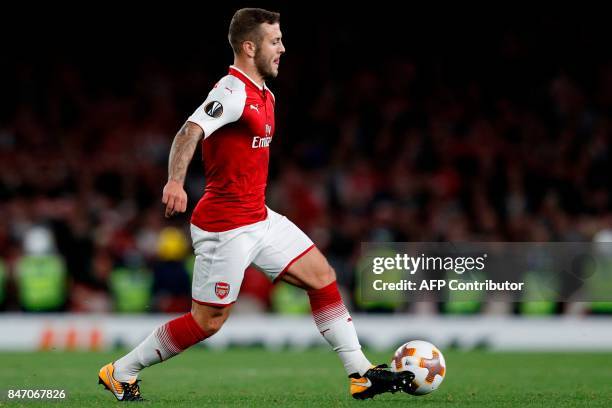 Arsenal's English midfielder Jack Wilshere runs with the ball during the UEFA Europa League Group H football match between Arsenal and FC Cologne at...