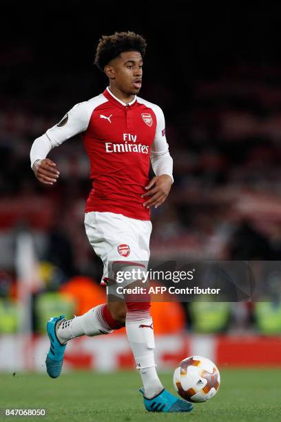Arsenal's English midfielder Reiss Nelson runs with the ball during the UEFA Europa League Group H football match between Arsenal and FC Cologne at...