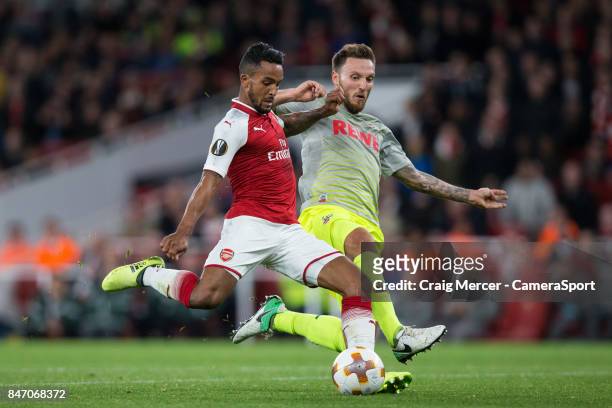 Arsenal's Theo Walcott shoots under pressure from 1.FC Koln's Marco Hoger during the UEFA Europa League group H match between Arsenal FC and 1. FC...