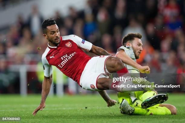 Arsenal's Theo Walcott shoots under pressure from 1.FC Koln's Marco Hoger during the UEFA Europa League group H match between Arsenal FC and 1. FC...