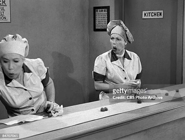American actresses Vivian Vance , as Ethel Mertz, and Lucille Ball , as Lucy Ricardo, work side-by side at a candy factory conveyor belt in an...