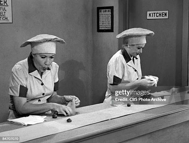 American actresses Vivian Vance , as Ethel Mertz, and Lucille Ball , as Lucy Ricardo, work side-by side at a candy factory conveyor belt in an...