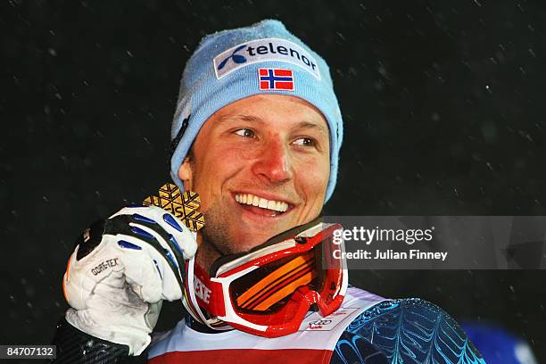 Aksel Lund Svindal of Norway celebrates with his gold medal following his overall victory in the Men's Super Combined event held on the Face de...