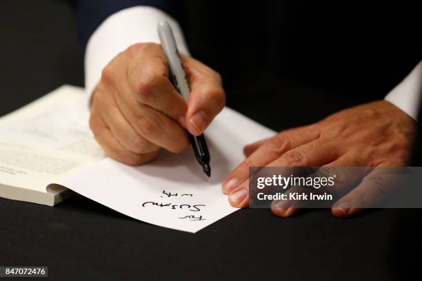 Chris Lee signs a copy of his book during the Summit of Greatness on September 14, 2017 in Columbus, Ohio.