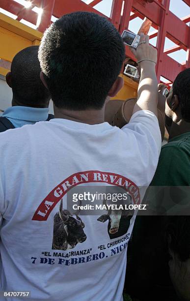 In Spanish By Ana Fernandez A boy wearing a t-shirt that reads "The Malacrianza and The Chirriche. The Great Revenge" tries to get a photo of the...
