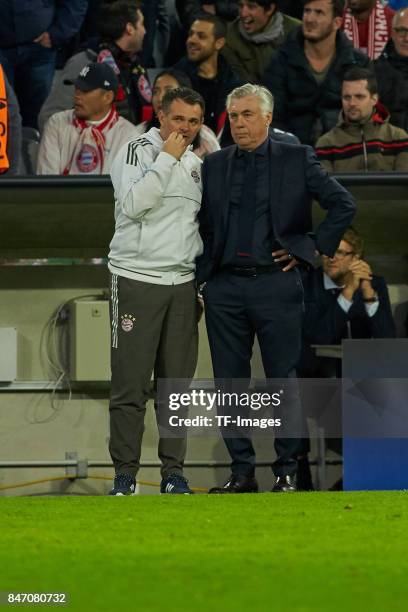 Co-coach Willy Sagnol of Bayern Muenchen speak with Head coach Carlo Ancelotti of Bayern Muenchen during the UEFA Champions League group B match...