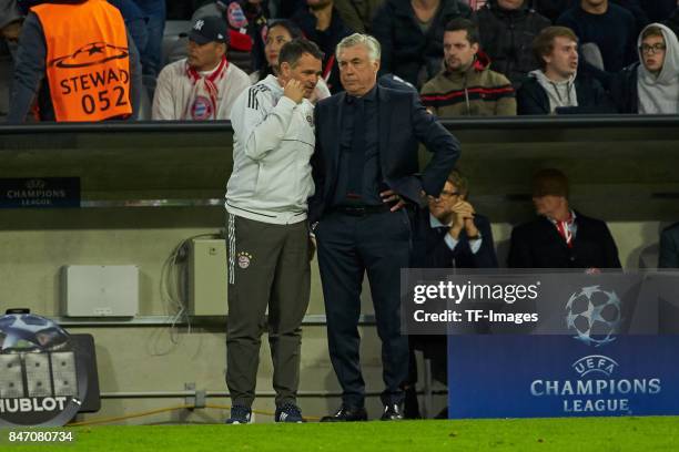 Co-coach Willy Sagnol of Bayern Muenchen speak with Head coach Carlo Ancelotti of Bayern Muenchen during the UEFA Champions League group B match...