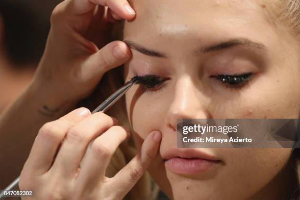 Model perpares backstage at the Tumbler And Tipsy By Michael Kuluva fashion show during New York Fashion Week: Style360 at Metropolitan Pavilion on...