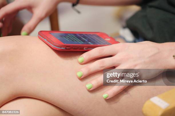 Model perpares backstage at the Tumbler And Tipsy By Michael Kuluva fashion show during New York Fashion Week: Style360 at Metropolitan Pavilion on...