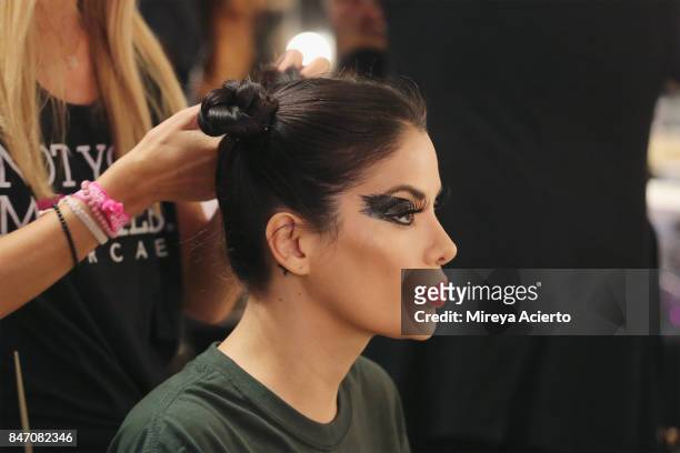 Model perpares backstage at the Tumbler And Tipsy By Michael Kuluva fashion show during New York Fashion Week: Style360 at Metropolitan Pavilion on...