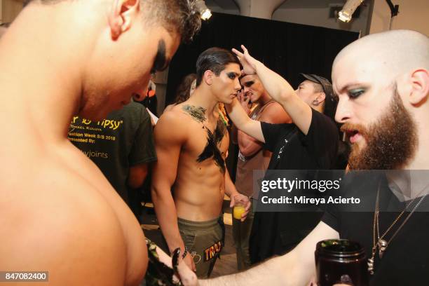 Model prepares backstage at the Tumbler And Tipsy By Michael Kuluva fashion show during New York Fashion Week: Style360 at Metropolitan Pavilion on...