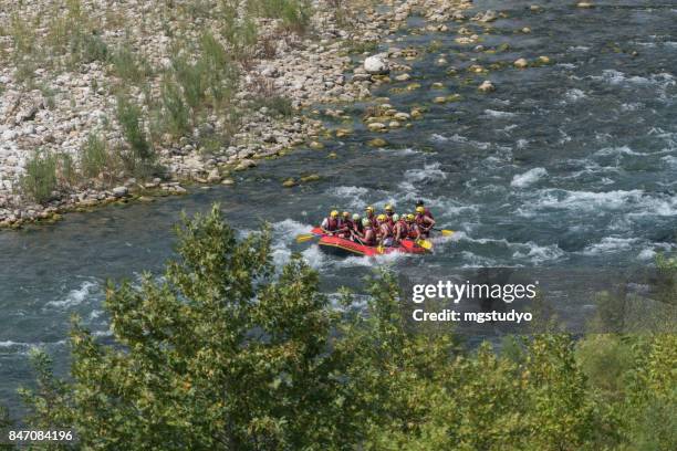 group of people white water rafting - white water rafting stock pictures, royalty-free photos & images