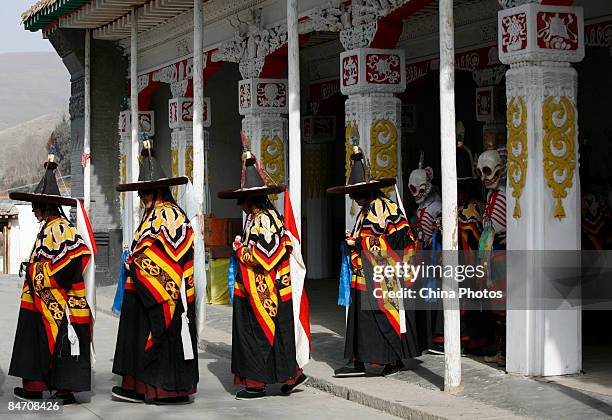 Lamas wait to dance during the "Tiaoqian" praying ceremony at the Youning Temple on February 8, 2009 in Huzhu County of Qinghai Province, China. The...