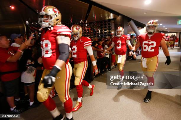 Zane Beadles, Brian Hoyer, C.J. Beathard and Erik Magnuson of the San Francisco 49ers head to the field prior to the game against the Carolina...