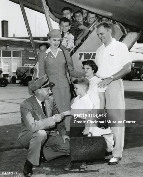 Pilot and stewardess greets the passengers coming off the plane, ca.1950s, Cincinnati, Ohio.