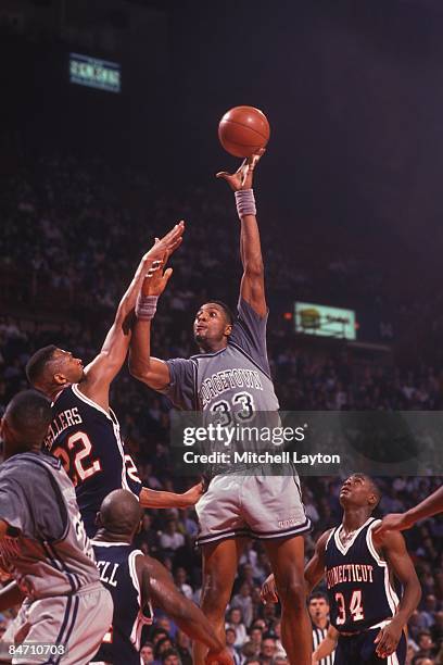 Alonzo Mourning of the Georgetown Hoyas takes a hook shot during a college basketball game against the Connectucut Huskies on February 19, 1992 at...