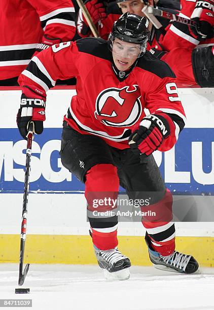 Zach Parise of the New Jersey Devils plays the puck against the Los Angeles Kings at the Prudential Center on February 7, 2009 in Newark, New Jersey....