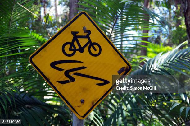 sign warning of a slippery cycling path in coffs harbour, new south wales, australia - varning för halka bildbanksfoton och bilder