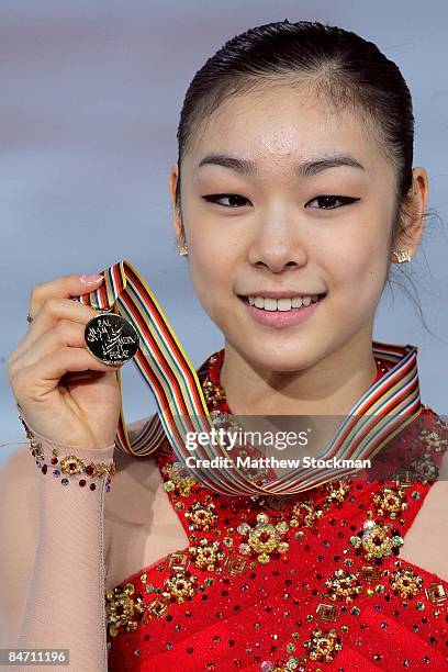 Yu-Na Kim of Korea poses for photographers with her medal after the Ladies Free Skate during the ISU Four Continents Figure Skating Championships at...