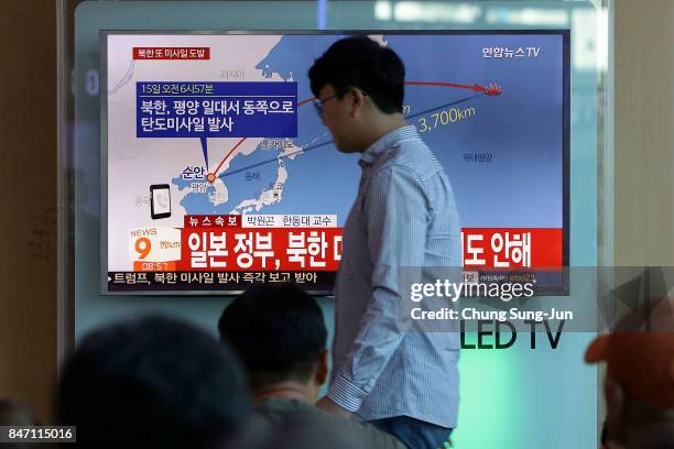 People watch a television broadcast reporting the North Korean missile launch at the Seoul Railway Station on September 15, 2017 in Seoul, South...