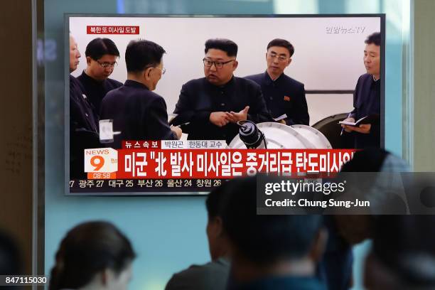 People watch a television broadcast reporting the North Korean missile launch at the Seoul Railway Station on September 15, 2017 in Seoul, South...