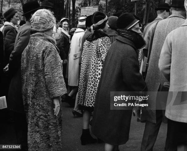 *Scanned low-res from print* Queen Elizabeth II, wearing a leopard skin coat, and the Queen Mother, left, wait to pass through the gate from the...