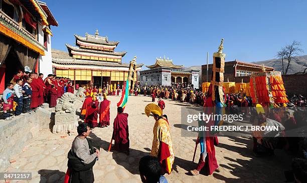 Crowd gathers to watch Tibetan Buddhist monks in a ceremony leading up to the "Sunning of the Buddha", when a huge thangka of Sakyamuni, the founder...