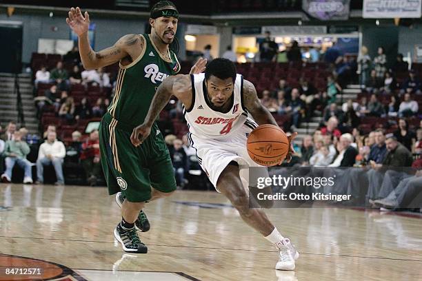 Jamaal Tatum of the Idaho Stampede drives past Majic Dorsey of the Reno Bighorns during the D-League game on January 15, 2009 at Qwest Arena in...