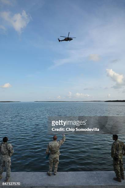 Soldiers from the Florida National Guard's Delta Company, 1st Battallion, 124th Infantry, 53rd Infantry Brigade Combat Team watch a military...