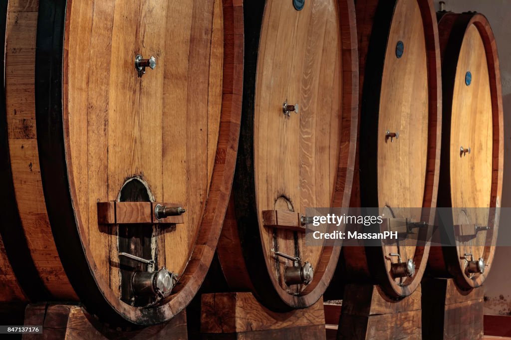 Four large oak casks in a wine cellar