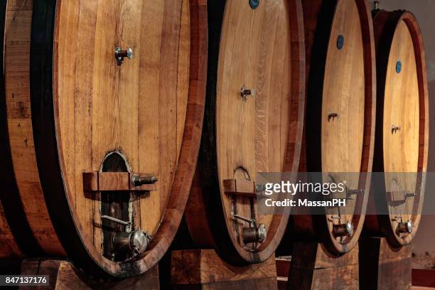 four large oak casks in a wine cellar - madeira material stock pictures, royalty-free photos & images