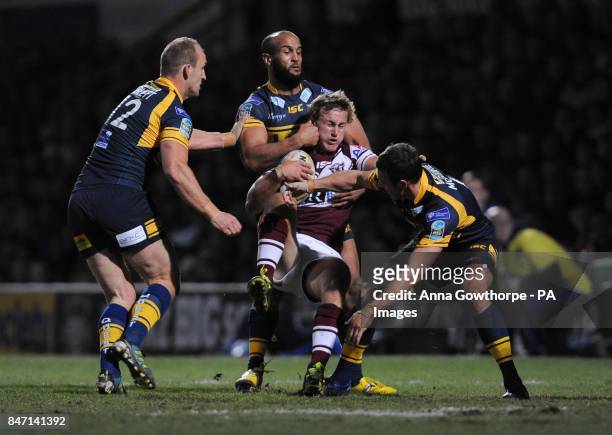 Manly Sea Eagles' Daly Cherry-Evans is tackled by Leeds Rhinos' Carl Ablett , Jamie Jones-Buchanan and Danny Maguire during the World Club Challenge...