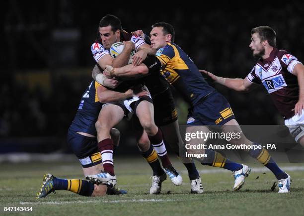 Manly Sea Eagles' Michael Oldfield is tackled by Leeds Rhinos' Carl Ablett and Kevin Sinfield during the World Club Challenge match at Headingley,...