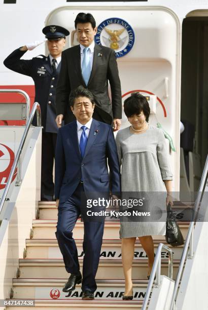 Japanese Prime Minister Shinzo Abe and his wife Akie arrive at Tokyo's Haneda airport on Sept. 15 after visiting India. North Korea launched another...